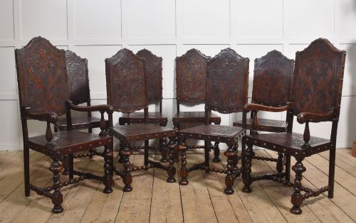 SET OF EIGHT PORTUGUESE EMBOSSED LEATHER AND WALNUT DINING CHAIRS