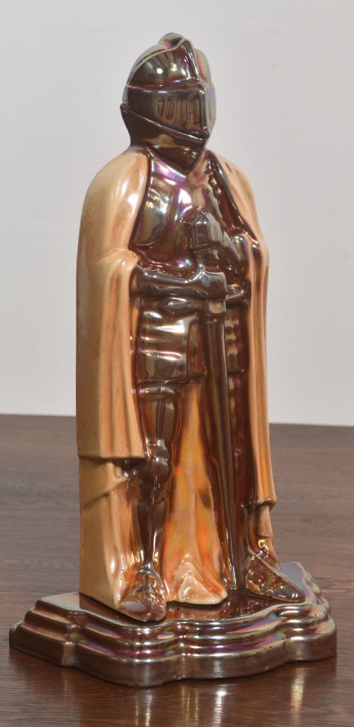 A metallic knight in full armour fireside companion stand holding a shovel and tongs, with a matching brush resting beside it. View VII