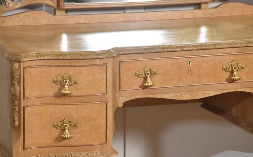 fig 1. A light burr walnut dressing table featuring five drawers, brass handles, carved cabriole legs, a three-piece folding mirror, and a matching upholstered stool.