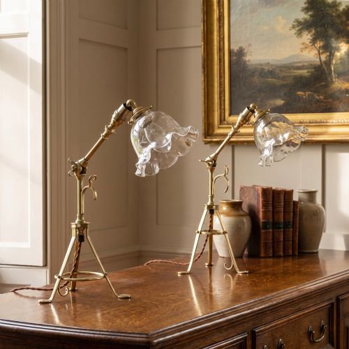 fig 1. A pair of antique brass adjustable lamps featuring tripod bases with pad feet, central articulated joints with wing nuts, and tilting bulb holders.