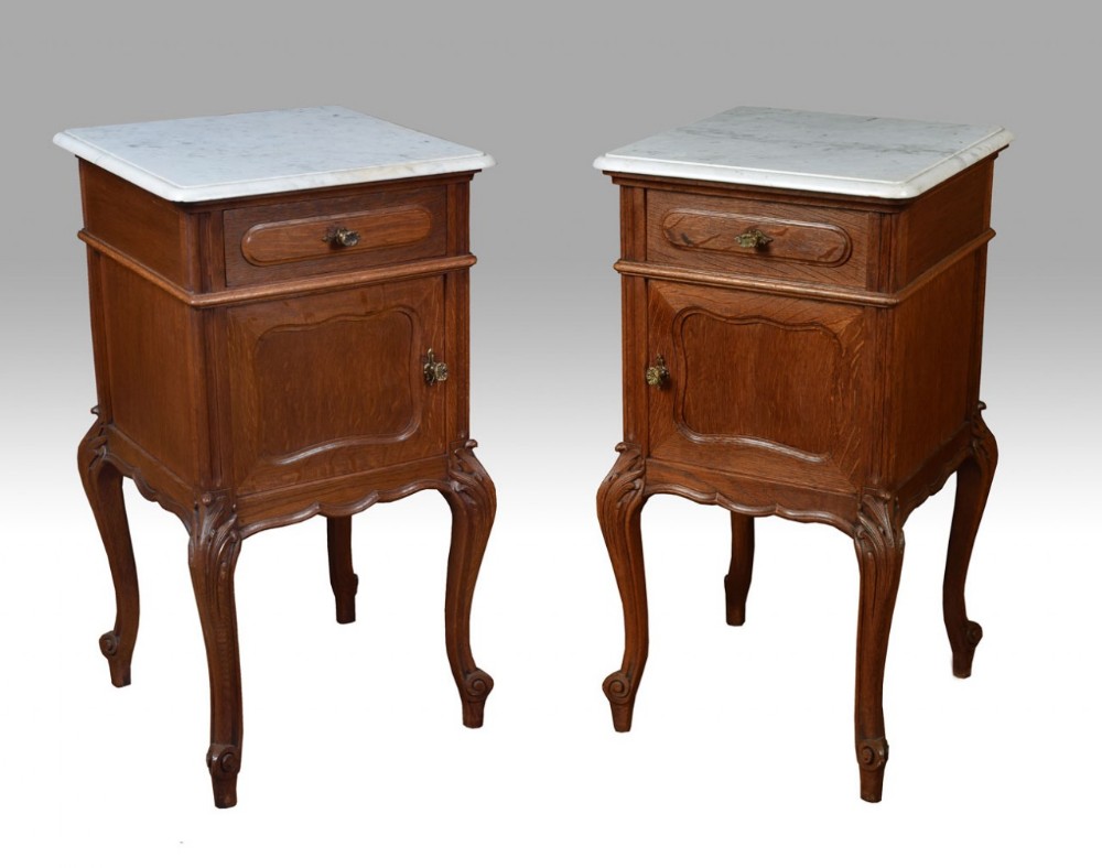 Pair of oak marble top bedside cabinets