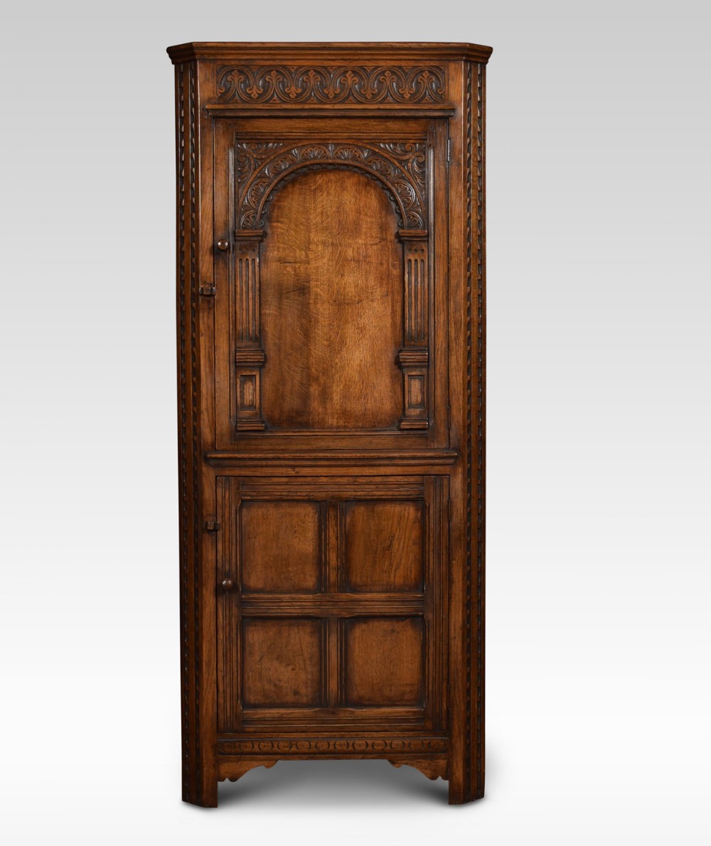 Carved oak corner cupboard