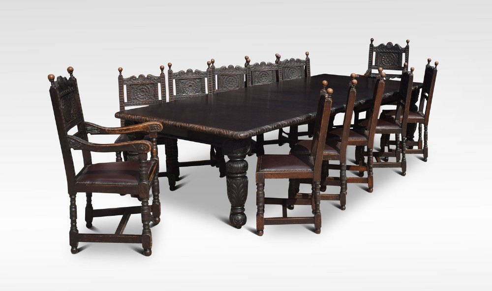 Carved oak dining table and chairs