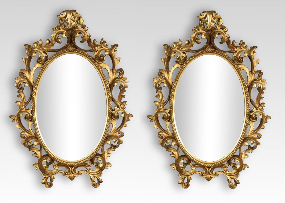 Pair of oval giltwood wall mirrors