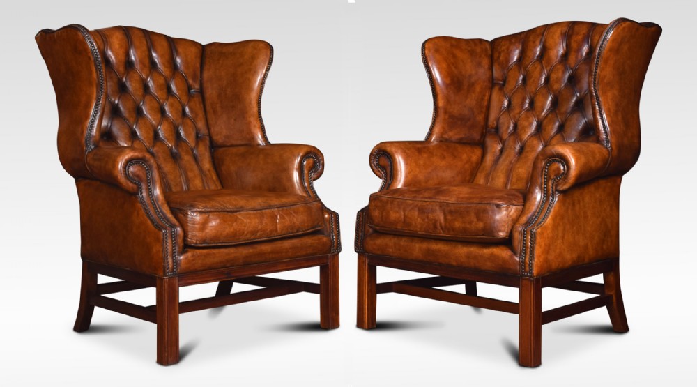 Pair of Leather upholstered wingback armchairs