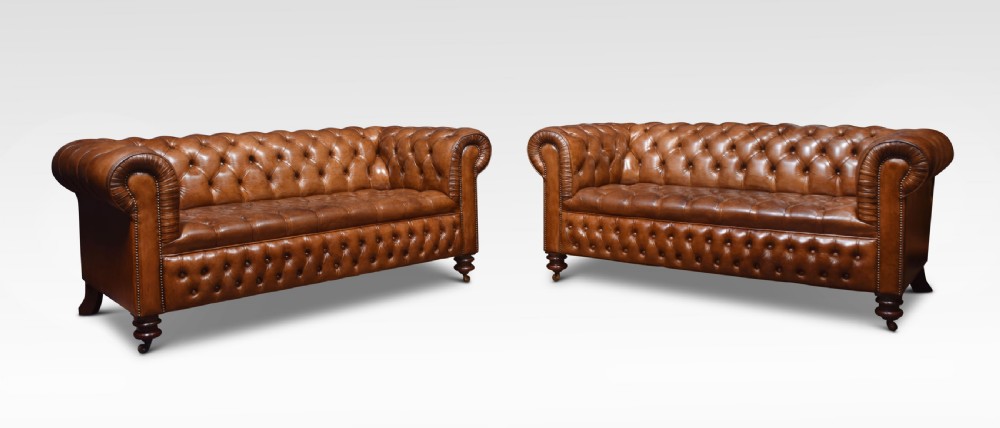 Pair of brown leather chesterfields