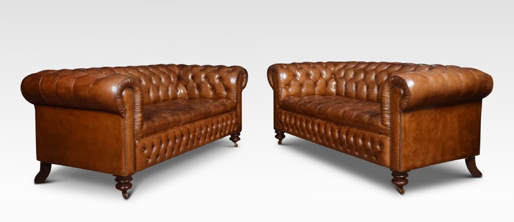 Pair of brown leather chesterfields View II