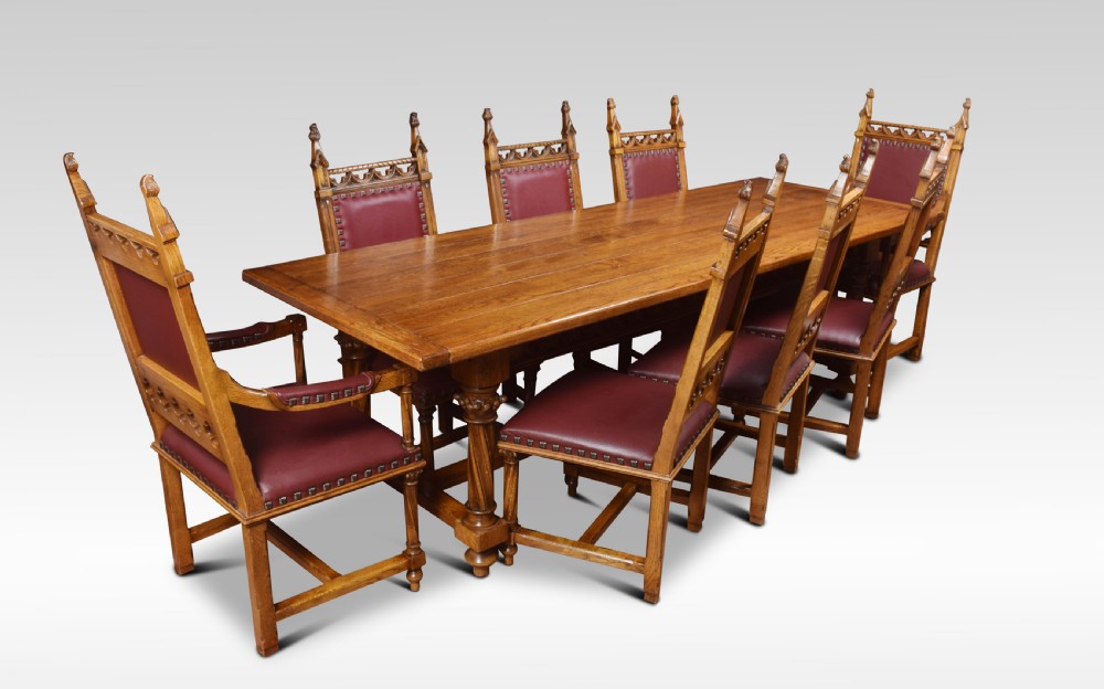 Gothic design oak refectory table and eight chairs