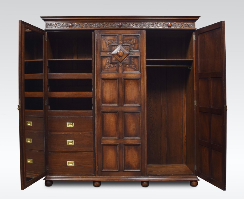 Jacobean style carved oak three door wardrobe View II