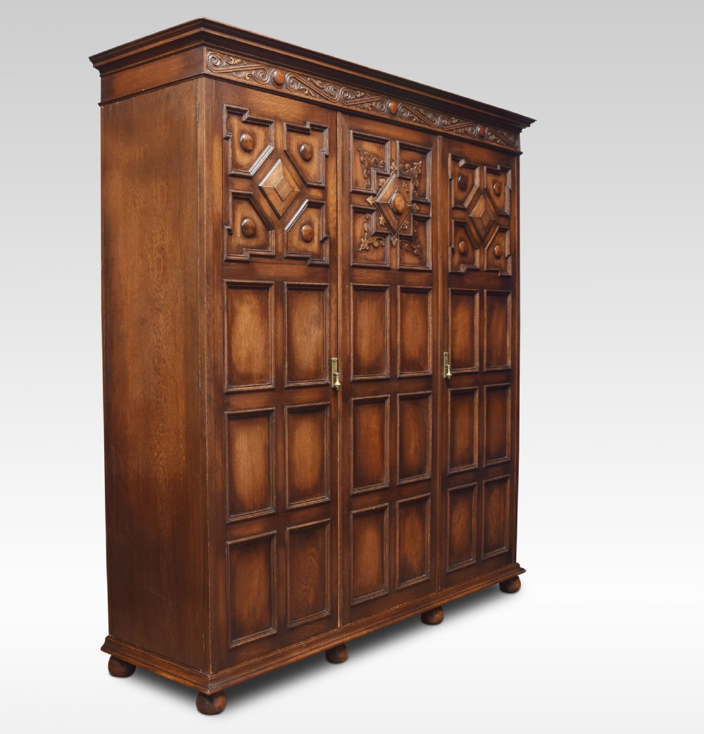 Jacobean style carved oak three door wardrobe View III