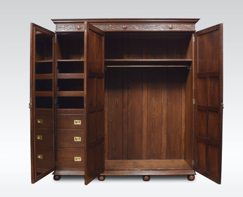 Jacobean style carved oak three door wardrobe View IV