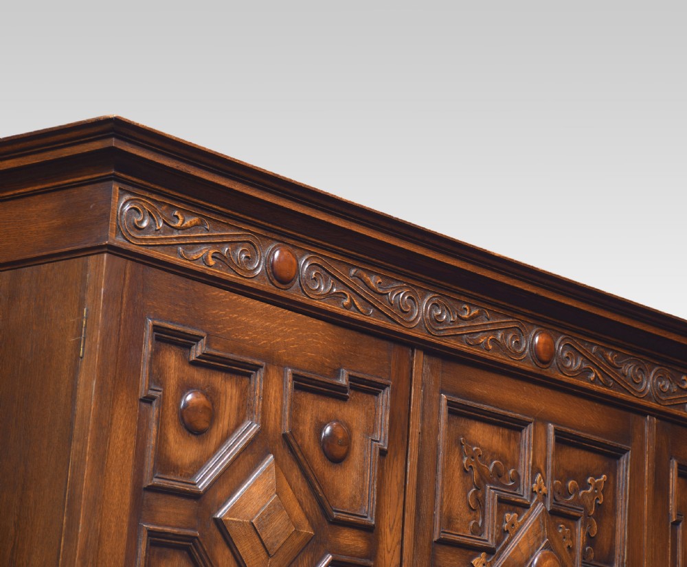Jacobean style carved oak three door wardrobe View VI