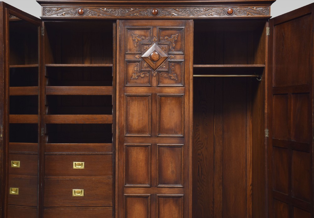 Jacobean style carved oak three door wardrobe View VII