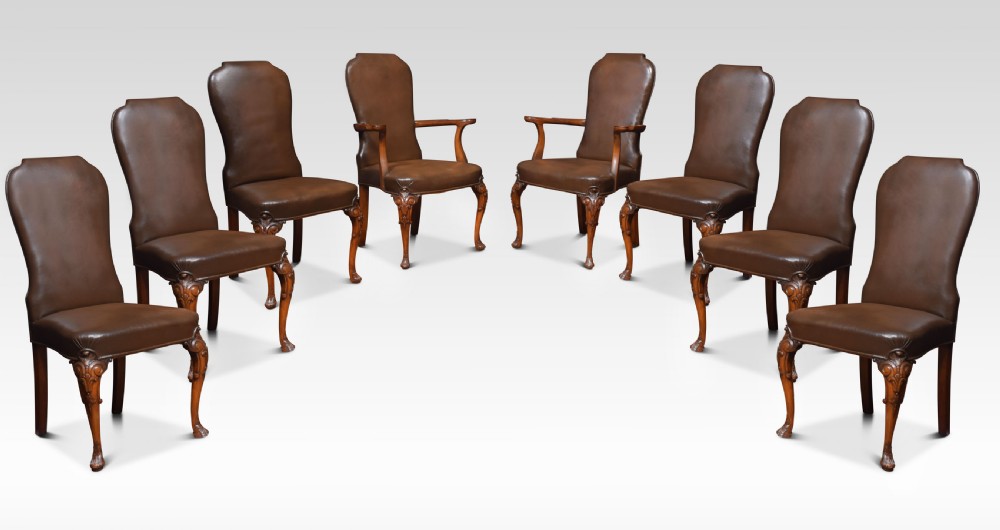 Set of eight high back brown leather upholstered dining chairs