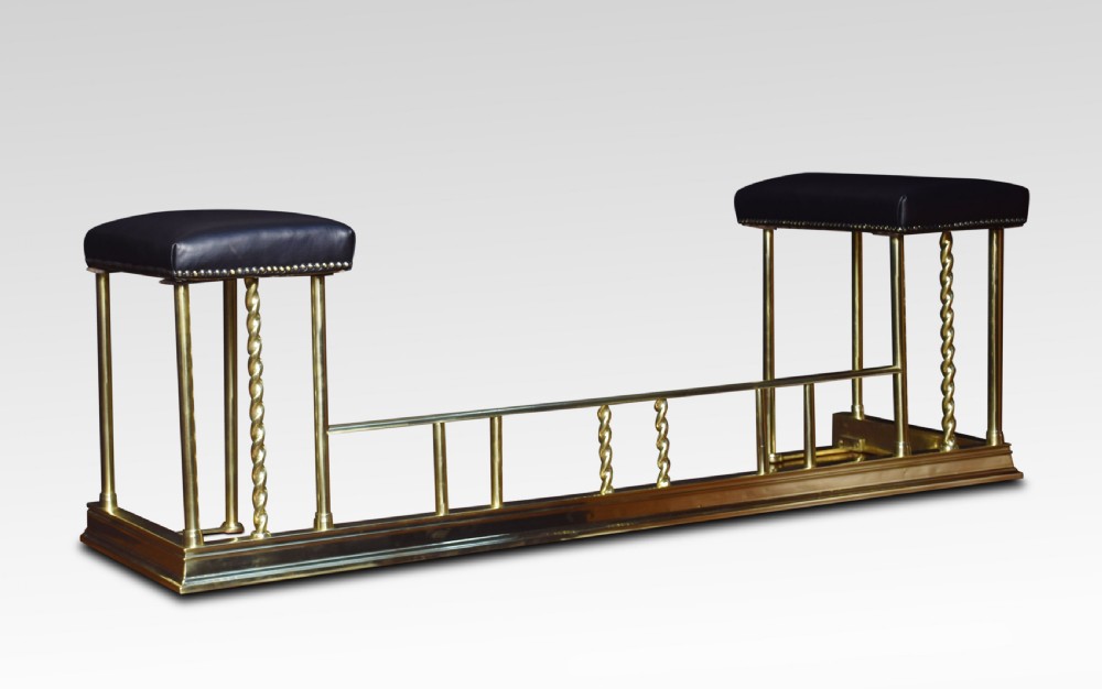 Edwardian brass and leather upholstered club fender