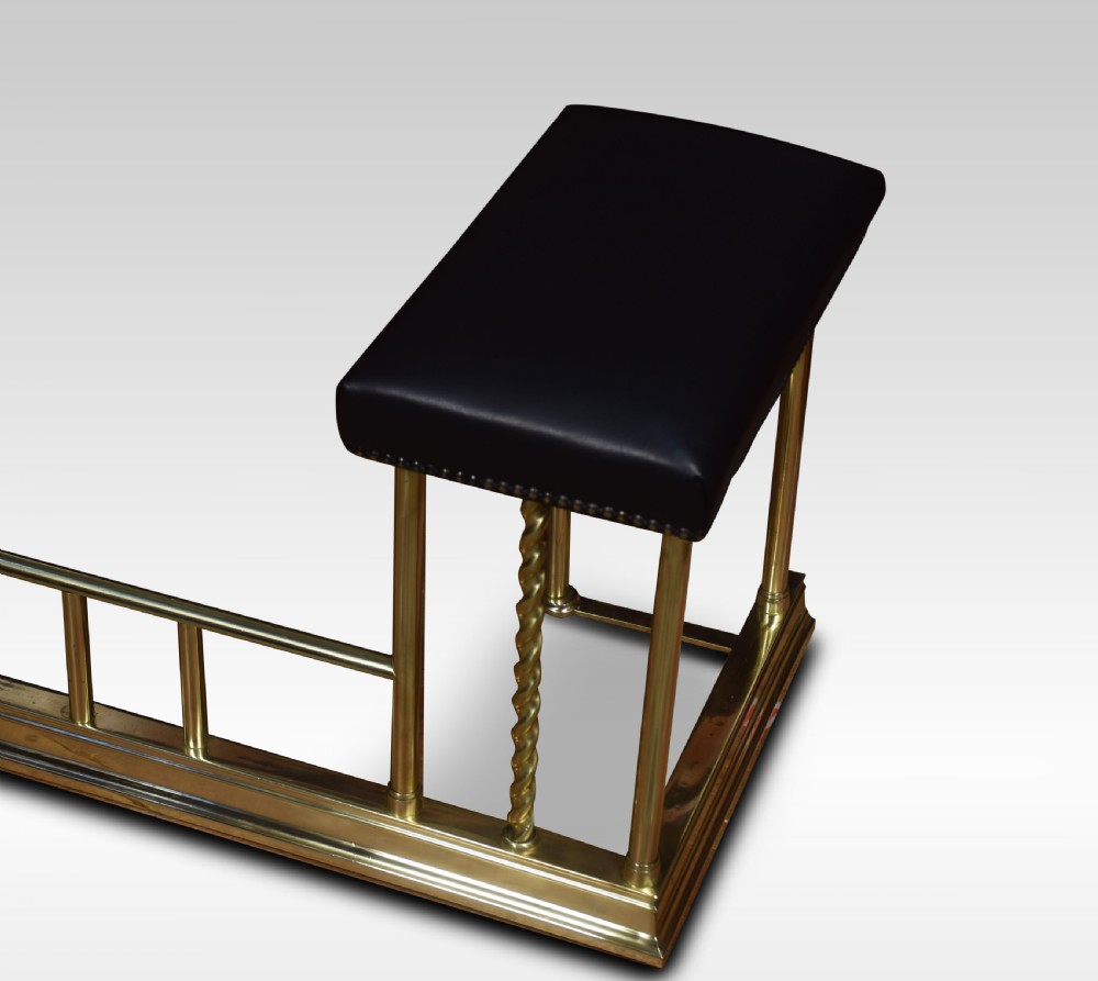 Edwardian brass and leather upholstered club fender View VI