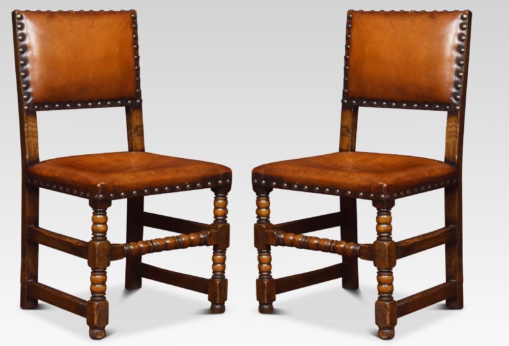 Eight leather upholstered oak dining chairs View IV