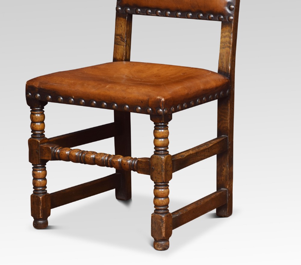 Eight leather upholstered oak dining chairs View V