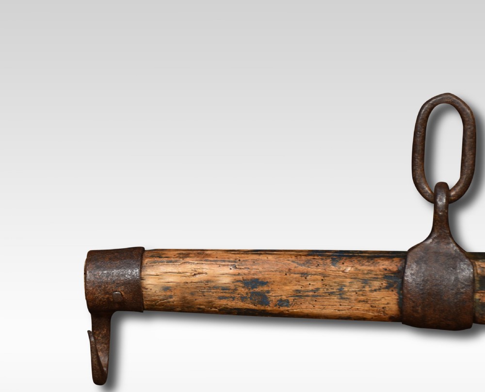 A cylindrical carved oak draught yoke featuring hand-forged wrought iron end hooks and a central iron mounting loop. View III