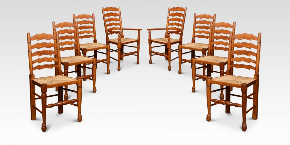 Set of eight fruitwood ladder back dining chairs