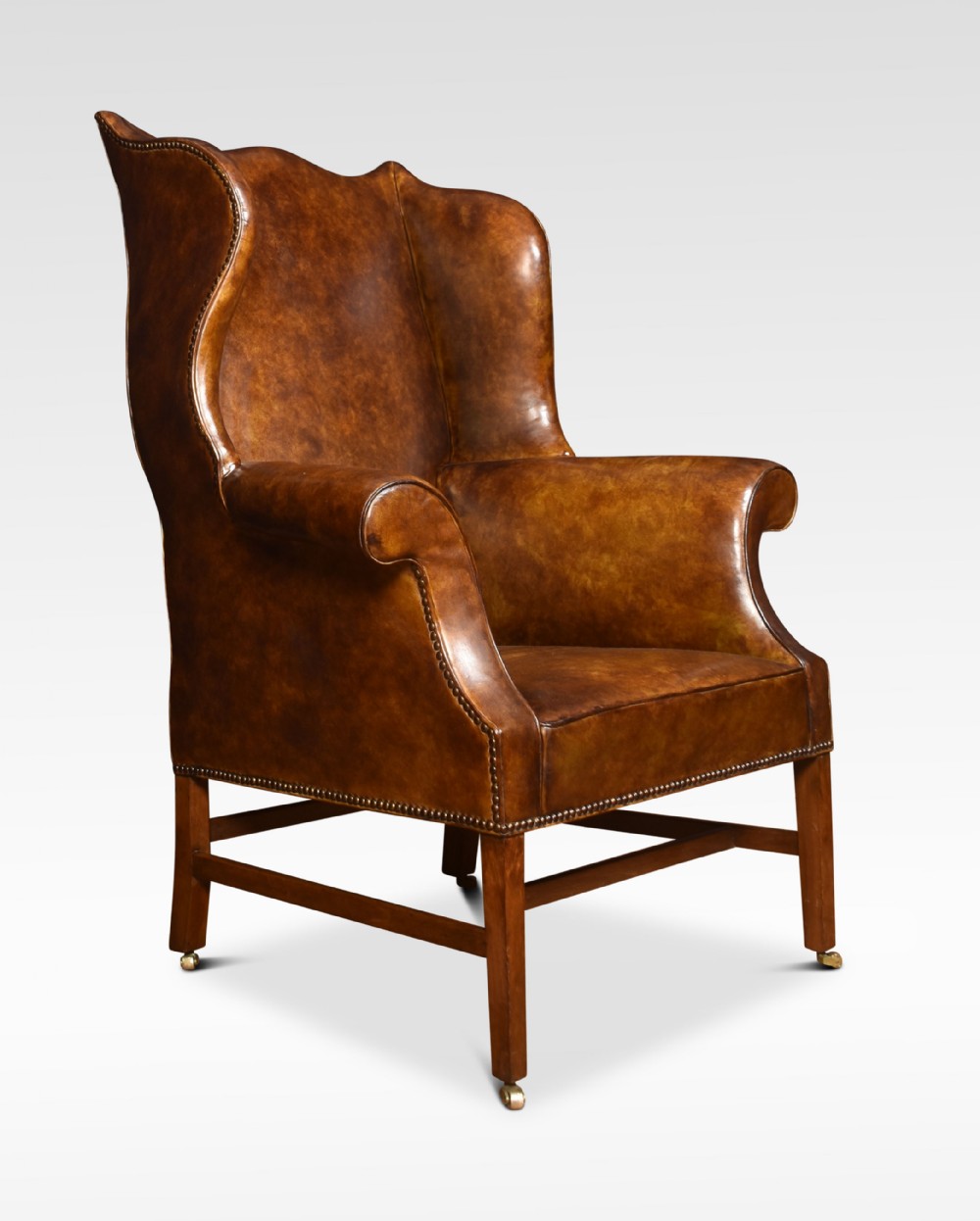 Brown leather upholstered wingback armchair