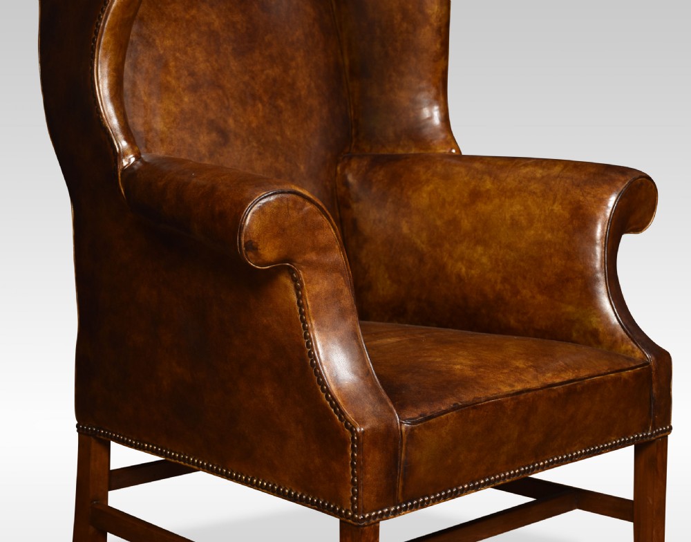 Brown leather upholstered wingback armchair View II