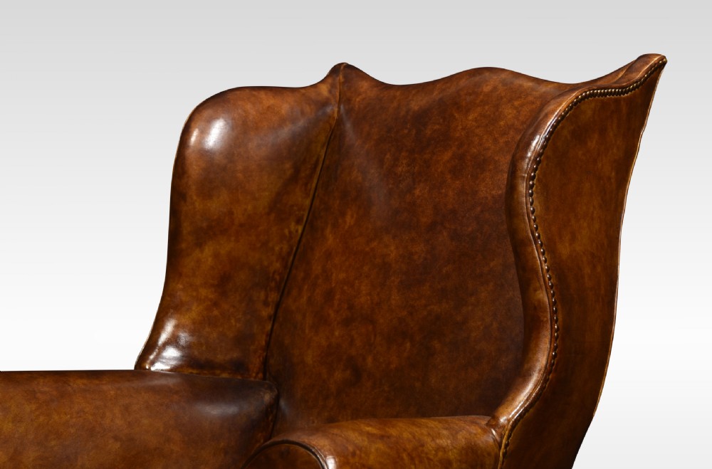 Brown leather upholstered wingback armchair View VII