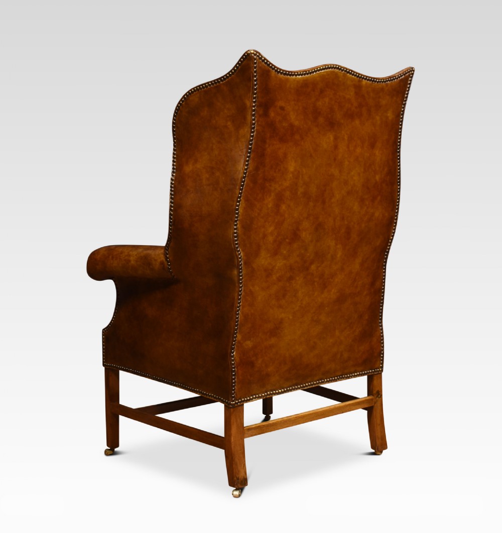 Brown leather upholstered wingback armchair View VIII