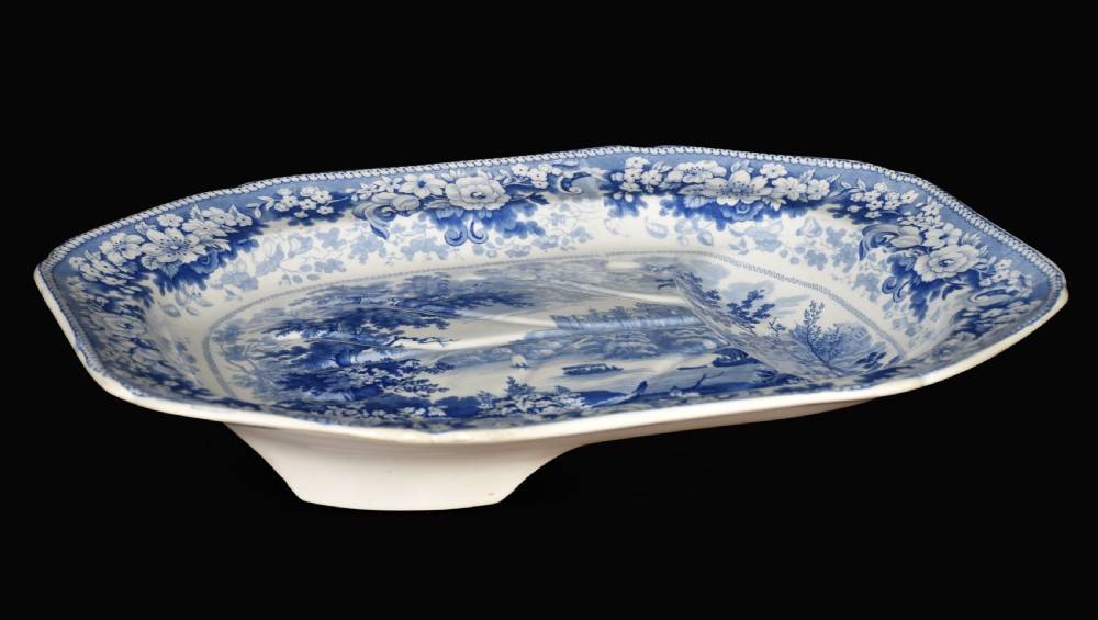 A 19th-century Staffordshire deep rectangular dish featuring cobalt blue transfer-printed floral borders and a central river landscape scene. View V