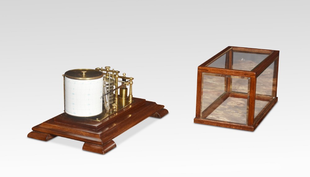 An antique barograph with a brass recording mechanism, clockwork drum, and integrated thermometer inside a glazed walnut case with a stepped base. View II