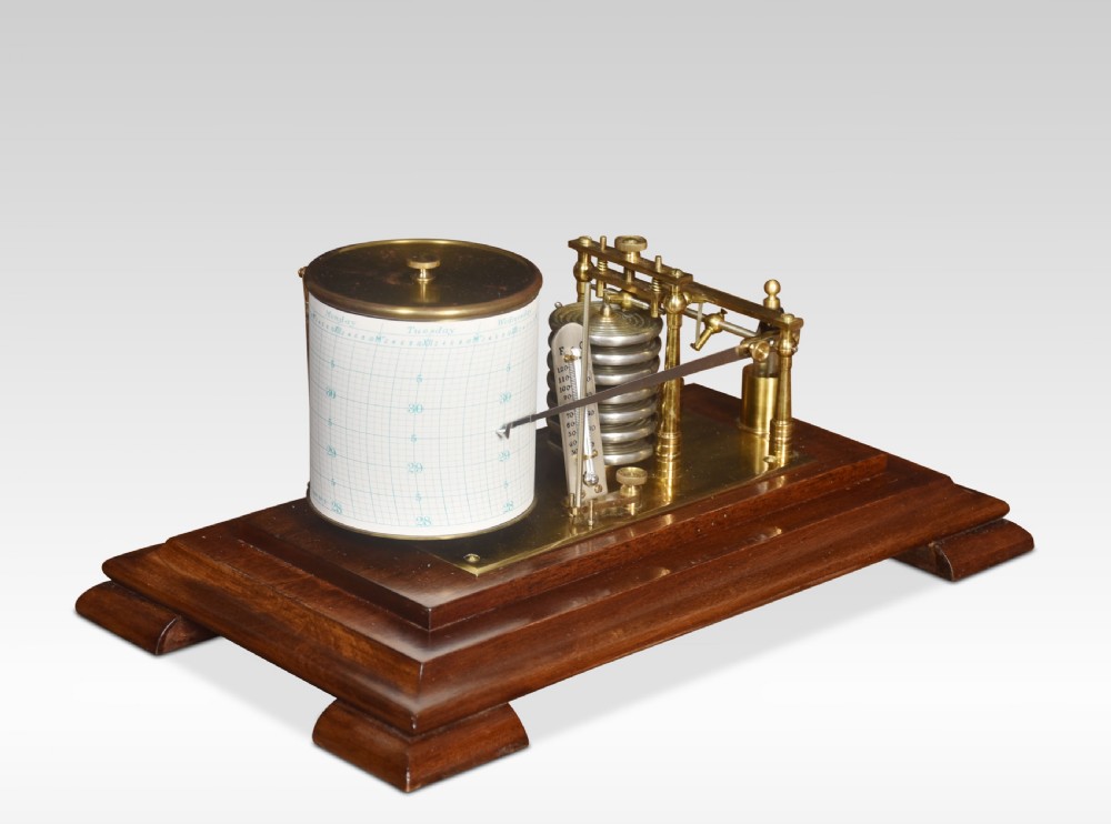 An antique barograph with a brass recording mechanism, clockwork drum, and integrated thermometer inside a glazed walnut case with a stepped base. View III