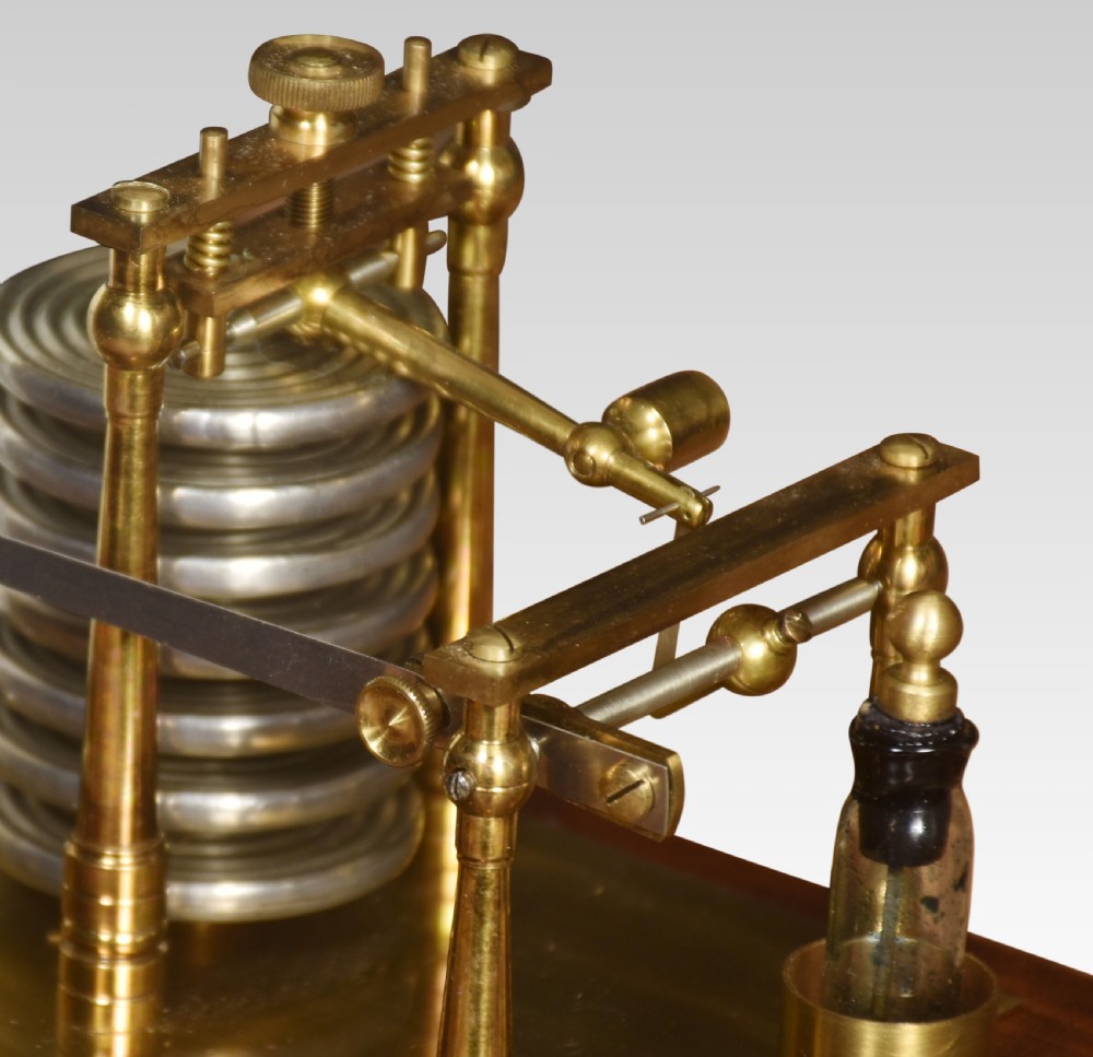 An antique barograph with a brass recording mechanism, clockwork drum, and integrated thermometer inside a glazed walnut case with a stepped base. View V