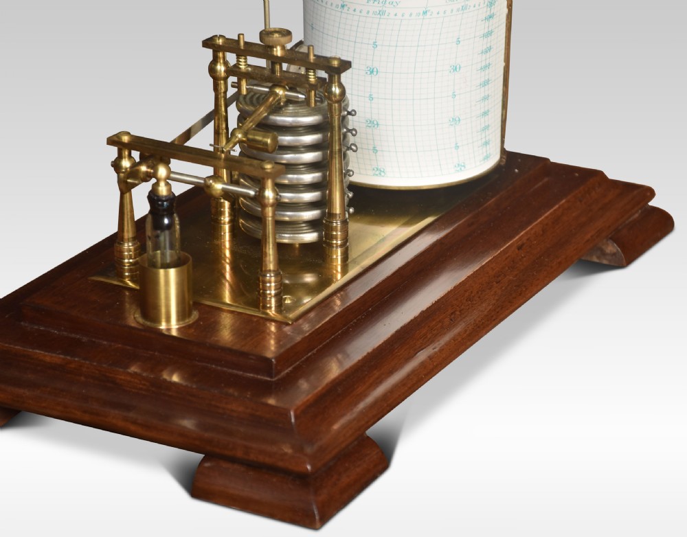 An antique barograph with a brass recording mechanism, clockwork drum, and integrated thermometer inside a glazed walnut case with a stepped base. View VI