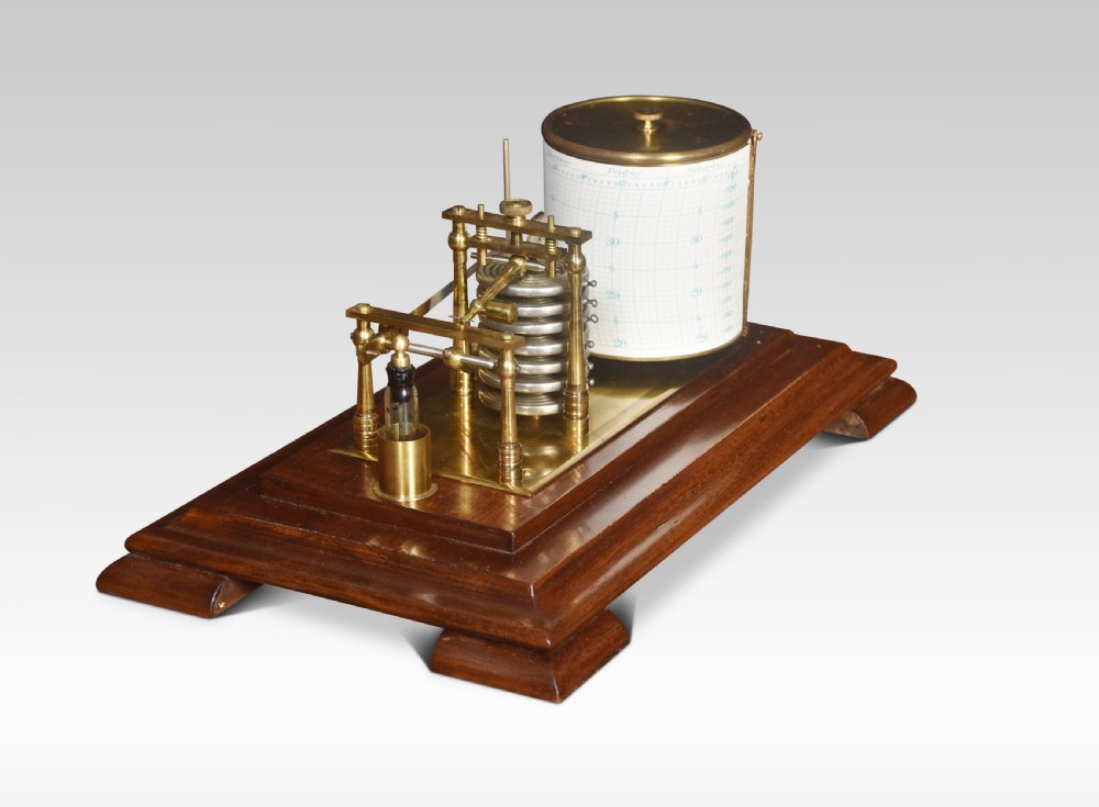An antique barograph with a brass recording mechanism, clockwork drum, and integrated thermometer inside a glazed walnut case with a stepped base. View VII
