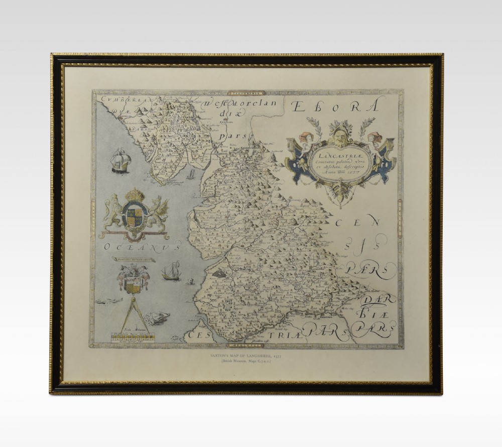 A framed antique map of Lancashire featuring hand-coloured detail, ornate cartouches, and a dark wooden frame with gold inner trim.