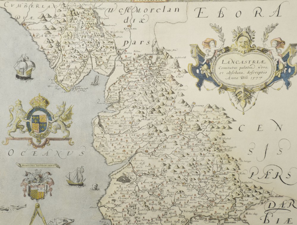 A framed antique map of Lancashire featuring hand-coloured detail, ornate cartouches, and a dark wooden frame with gold inner trim. View II