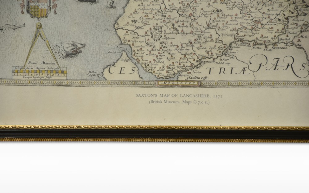 A framed antique map of Lancashire featuring hand-coloured detail, ornate cartouches, and a dark wooden frame with gold inner trim. View VI