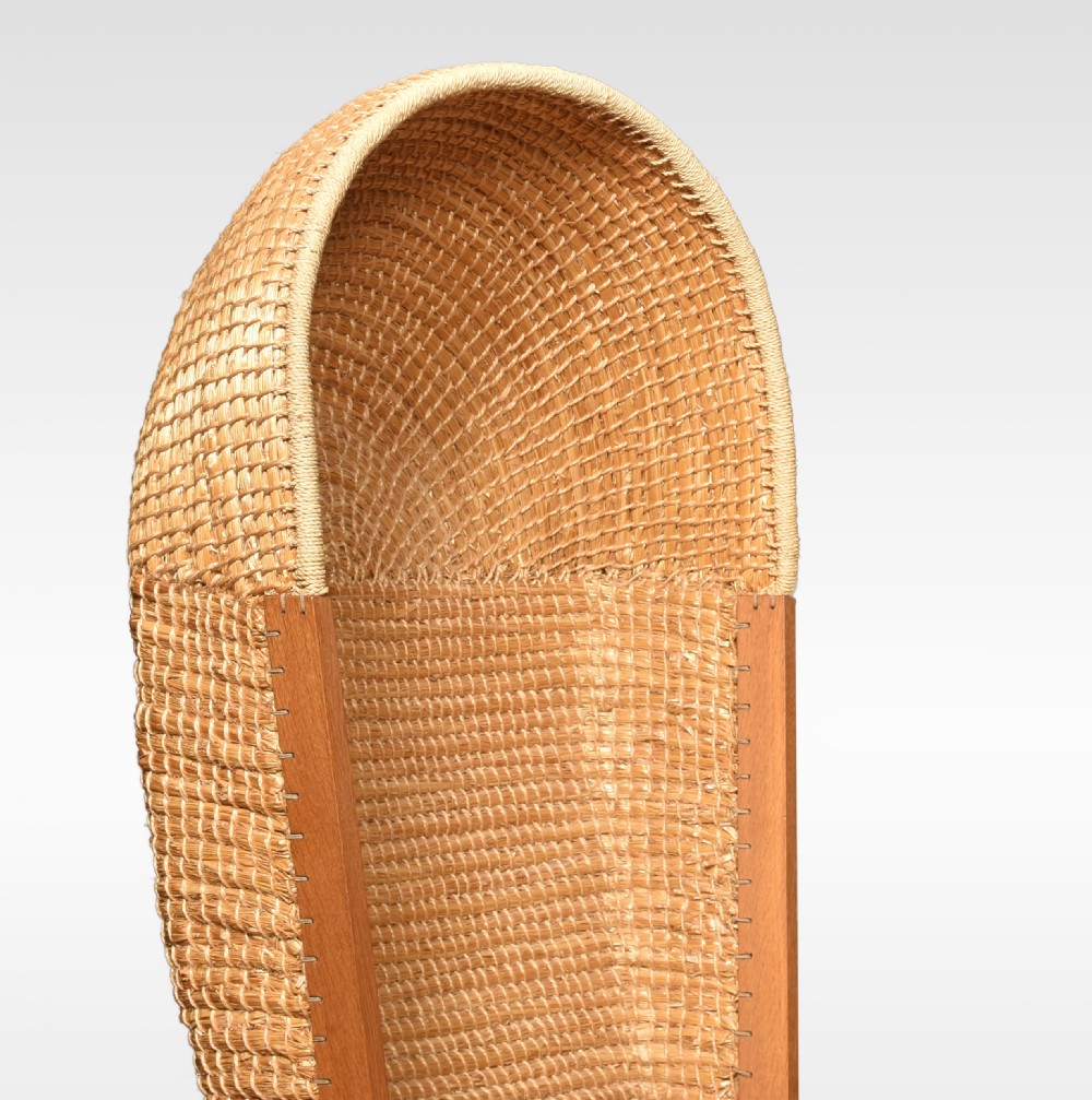 An antique oak-framed Orkney chair featuring a high curved hooded back woven from natural straw and flat timber armrests. View VII