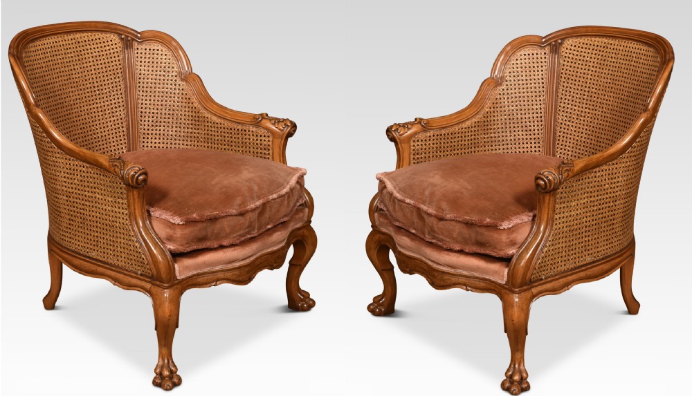 Pair of walnut bergere arm chairs