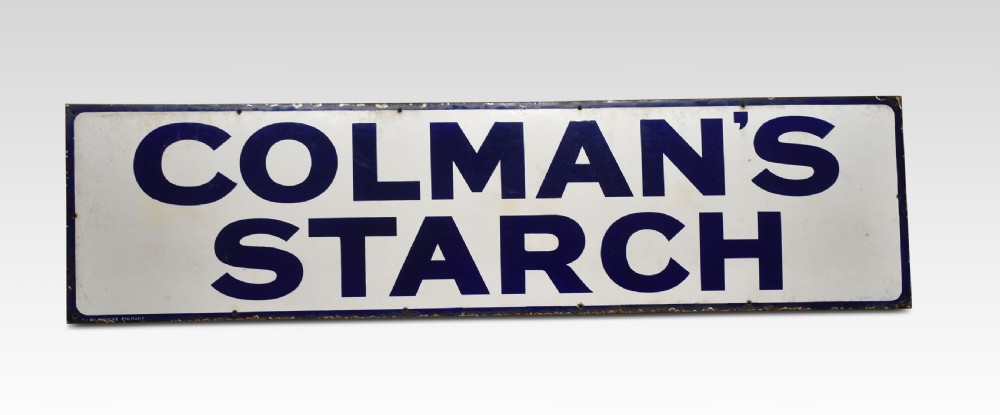 A rectangular antique vitreous enamel sign featuring dark blue block lettering reading COLMANS STARCH on a white background with a dark blue border.