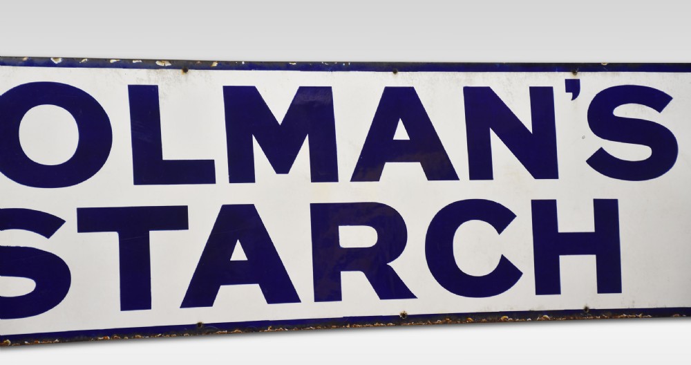 A rectangular antique vitreous enamel sign featuring dark blue block lettering reading COLMANS STARCH on a white background with a dark blue border. View II