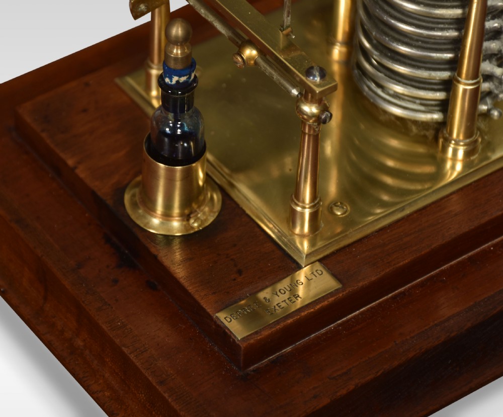 An antique walnut cased barograph featuring bevelled glass panels, a brass clockwork recording drum, and an aneroid mechanism set on a moulded wooden base. View III