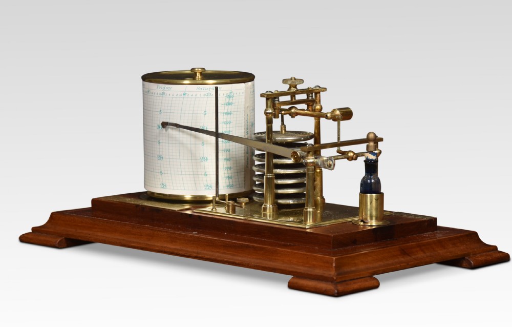 An antique walnut cased barograph featuring bevelled glass panels, a brass clockwork recording drum, and an aneroid mechanism set on a moulded wooden base. View V