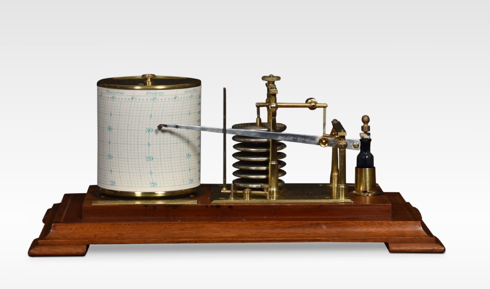 An antique walnut cased barograph featuring bevelled glass panels, a brass clockwork recording drum, and an aneroid mechanism set on a moulded wooden base. View VII