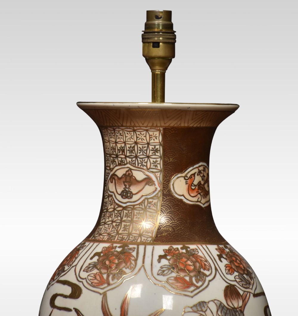 A Japanese Satsuma earthenware vase mounted as a table lamp base, decorated with hand-painted floral motifs in gold and terracotta enamels on a wooden stand. View IV