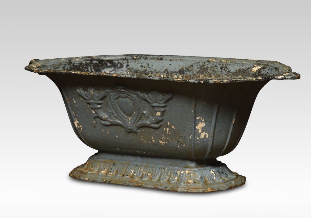 A pair of 19th-century slate grey cast iron trough planters with neoclassical relief decoration and a weathered paint finish. View II