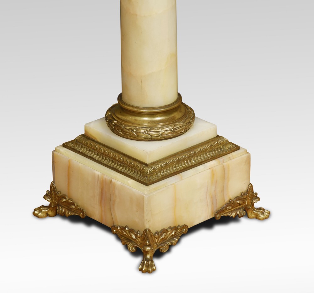 A tall cream onyx column pedestal with a square top, gilt bronze mounts, and decorative feet. View II