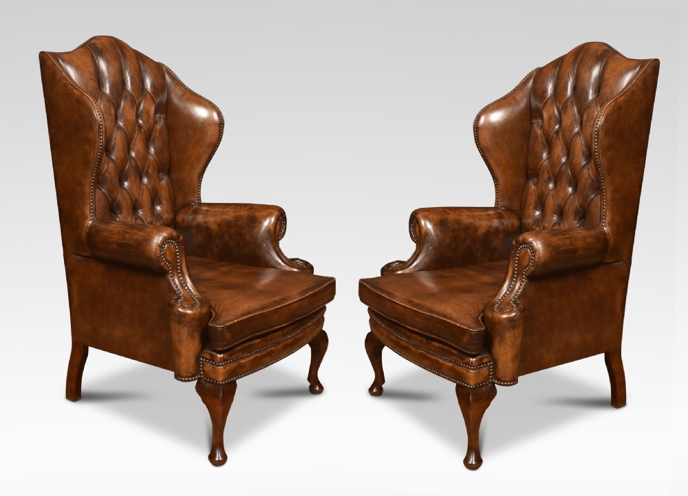 Pair of Leather upholstered wingback armchairs
