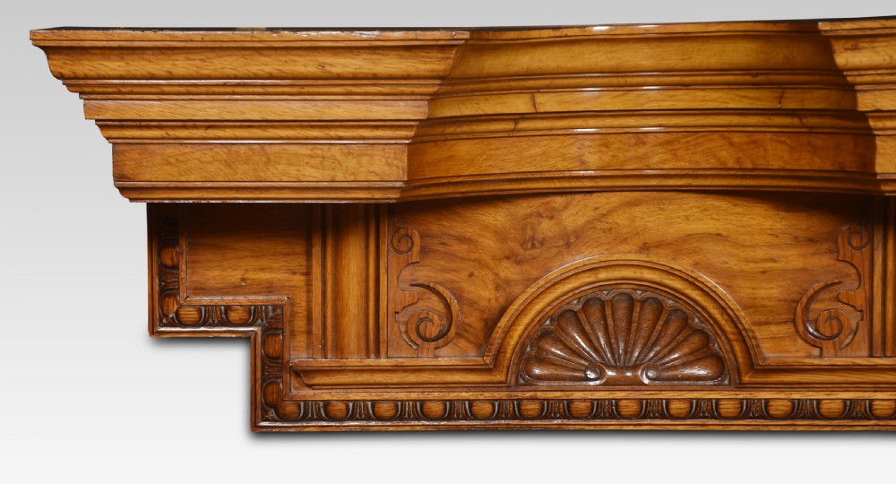 A carved pollard oak overdoor pediment featuring double carved shell motifs, stepped breakfront mouldings, and rich natural wood graining. View III
