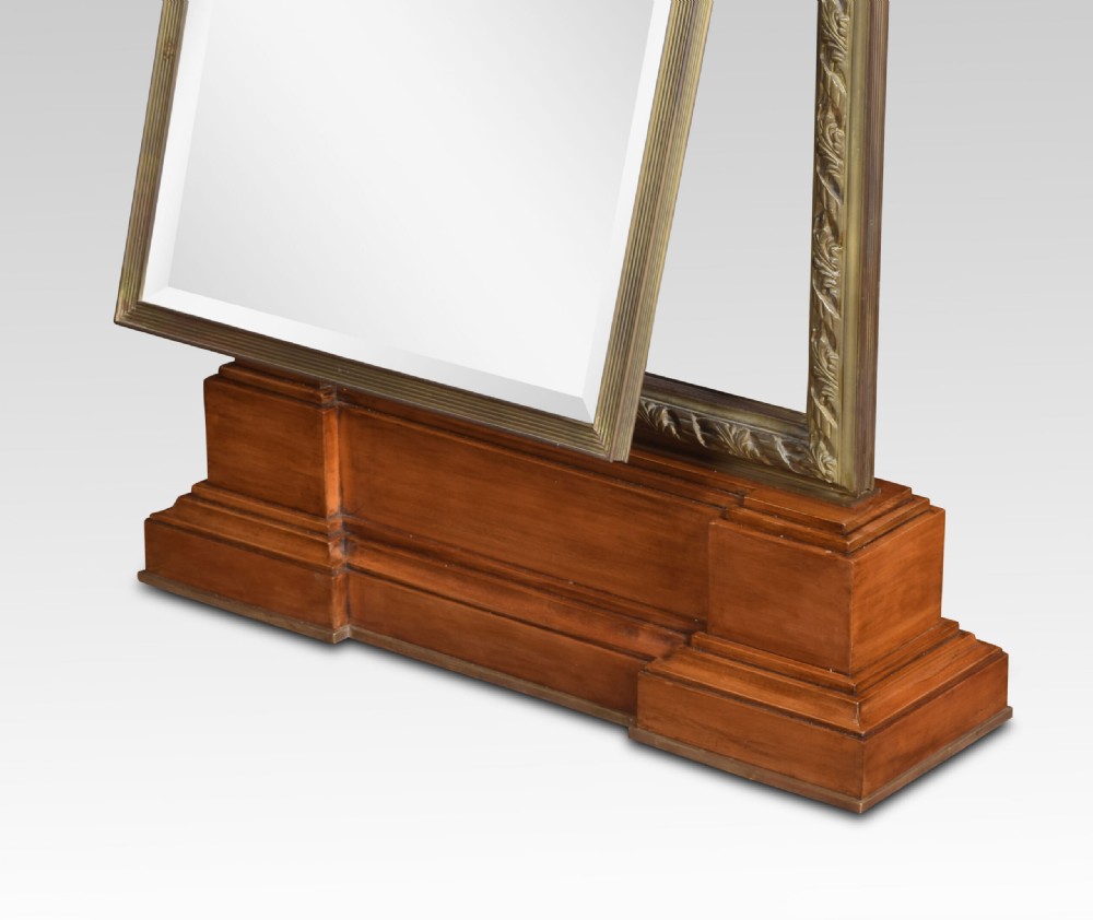 A pair of tall double-sided cheval mirrors featuring tooled bronze frames and wooden plinth bases. View IX
